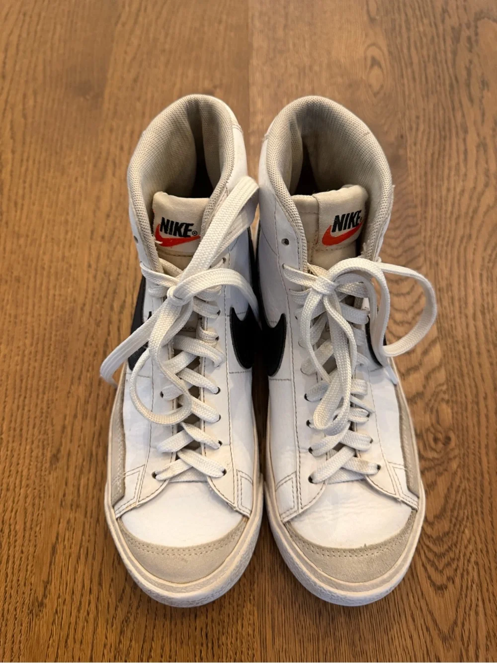 Nike White High-Top Sneakers with Black Swoosh